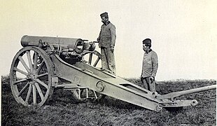 A rear view of the howitzer showing its box trail carriage and interrupted screw breech.