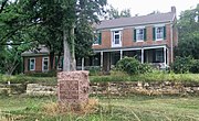 "Cedar Grove" (Amick-Kingsbury House). The 1909 Daughters of the American Revolution/State of Missouri Santa Fe Trail Monument is shown in the foreground. The Santa Fe Trail started in Franklin, just a few miles to the east, and ran directly in front of the house.