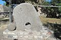 Monolith placed at the site entrance, structure 1 in the background