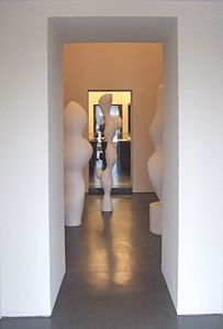View from outside into the basement with works by Hans Arp