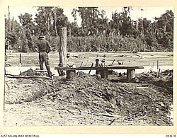 The construction of the first bridge across the Driniumor River by the 2/8th Field Company at Anamo, 23 November 1944