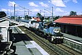 QR loco 2400 hauls an empty Sunlander consist through Yeronga station (in order to turn the train), 1987. The station has since been replaced with a brick structure