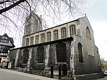 A stone church seen from the southeast, showing the south aisle, clerestory, and west tower