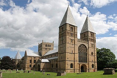 Southwell Minster 1108–1250, west front 1108–1150 (west window 1450). The severe twin-towered facade with balance of vertical buttresses and horizontal courses is similar to St Etienne, Caen. It has retained its simple spires.