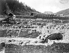 Gold Prince Mill construction, 1904: shows miners working on blasted embankments, a horse-drawn wagon, concrete forms, and a mixing plant.