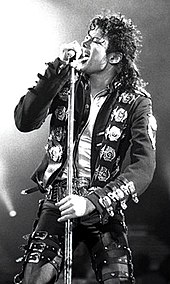 Black-and-white photograph of Michael Jackson performing live in 1988.