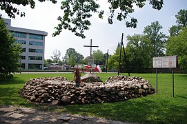 Commemoration site for the Warsaw concentration camp on Alojzy Pawelek square, an unofficial gathering place of Trzcińska's supporters. The site consists of a round place surrounded by stones. At one side of the site appears a large stone with an inscription repeating Trzcińska's number, behind which stands a metal cross. Information boards outlining Trzcińska's hypothesis appear on either side of the site