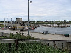 Fishermen's wharf,[21] sheds, fishing vessels and zodiac, Tonnerre River