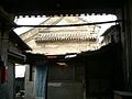 A grand screen wall covered by the shabby hut