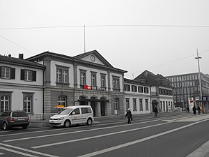 Two-story station building with multiple rooflines