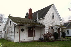 Photograph of the Gorman House, with a one-story wing on the left and a two-story wing on the right