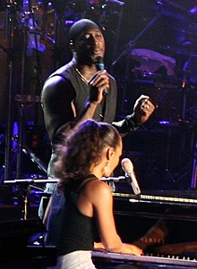 Paul performing with Alicia Keys in foreground; 2006