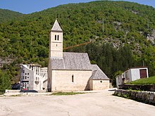 Simple white church on a hillside