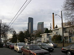 Yesler Way cuts through Yesler Terrace. The Columbia Center and other downtown skyscrapers can be seen in center background, and the upper part of Harborview Medical Center is just visible at right.