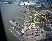 An aerial view of the destroyer USS Barry (DD-933) docked at the Washington Navy Yard, 15 April 1984