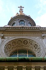 Window decoration and a spire sit atop the dome