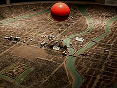 Former model of Hiroshima City flattened after the explosion. The red ball depicts the explosion point.