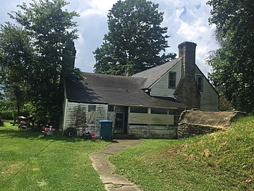 North side of house showing rear extension, and, to the right, cellar mound facing to the house