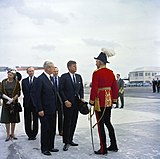 Major-General Sir Julian Gascoigne (right), wearing General officer's full dress as Governor of Bermuda (with Minister for Foreign Affairs the Earl of Home, Prime Minister Harold Macmillan, British Ambassador to the United States Sir David Ormsby-Gore, and United States President John F. Kennedy) in 1962.