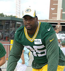 Photo of Jones wearing a jersey and a Packers hat