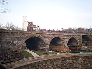 Main Street bridge, built in 1877 with the 1836 stone arch dam in the foreground, a relic of the P&O Canal