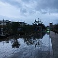 Le paysage urbain se reflète dans les flaques avec le nouveau revêtement de la place.