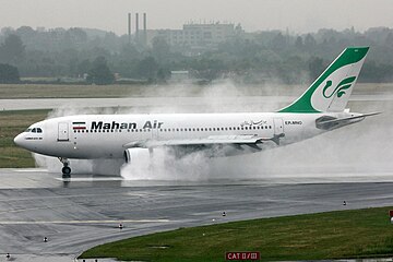 A Mahan Air Airbus A310 using reverse thrust in rainy weather at Düsseldorf Airport