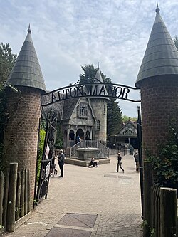 An entrance sign which states "Alton Manor". In the background is the ride exterior.