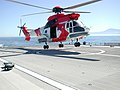 A helicopter touches down on a helideck on board the High Speed Vessel Swift
