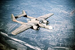 Color image of a two-seater airplane in flight