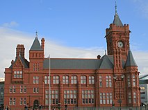 Victorian red brick building with clock tower to the right