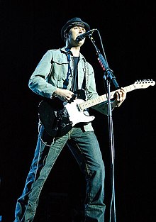 Kowalczyk playing guitar