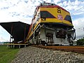 A Panama Canal Railway passenger train parked along the platforms of Colon station.