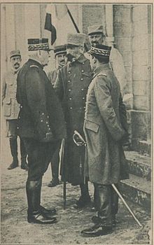 Photographie noir et blanc d'hommes en uniforme militaire qui discutent.