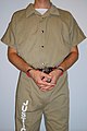 Inmate in belly chain with a handcuff cover (parallel position)