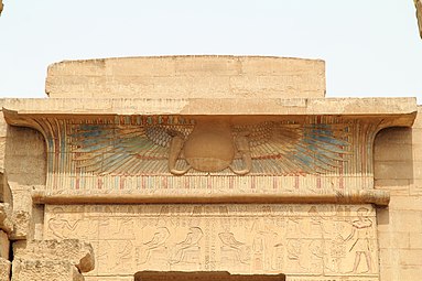 Winged sun on a cavetto from the Medinet Habu temple complex. The winged sun represents a form of the falcon god Horus, son of Isis, triumphant over his enemies. The image was also a common protective device over temple entrances.