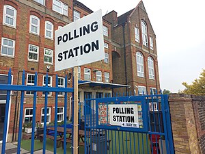 A primary school in the borough of Lewisham being used as a polling station on 2nd May 2024. It is an old Victorian building and has two signs reading "POLLING STATION" in capital letters.