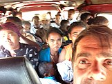 The interior of a crowded taxi brousse.