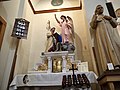 Wood carve statues to the side of the altar.