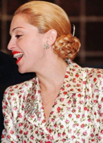 Madonna dressed as Eva Peron smiling