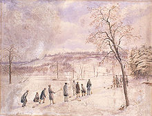 group of people on the ice of a pond