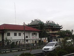 View of the barangay hall and the Kiu Pat Liong Shiao Temple from the Manila–Cavite Expressway