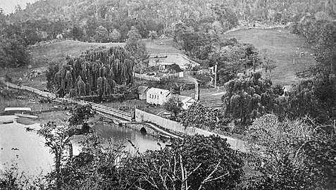 Kohukohu c. 1867-1869. The old stone bridge is clearly visible, before the harbour was filled in