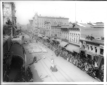 The east side of Spring Street, north of First, during the Fiesta de Los Angeles in 1903. The Bullard Block is in the distance at the top, center left.