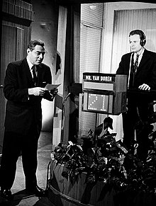 Black and white image of Twenty-One host Jack Barry on the left, and Charles Van Doren on the right.