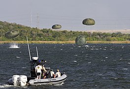 image of soldiers and state personal doing airborne training and water rescue drills over Walter E. Long Lake