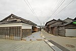 Wooden and black tile-roofed ship-owner houses.