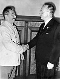 Stalin and Ribbentrop shaking hands after signing the Molotov–Ribbentrop Pact