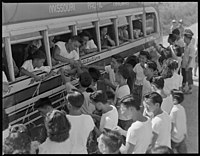 Japanese-American youths are transported to the Rohwer War Relocation Center aboard a Missouri Pacific Trailways bus, 1944