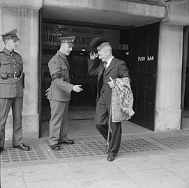 Mr Bill Krepper, late of the Pioneer Corps, leaves the demobilisation clothing depot at Olympia, London, wearing his demob suit.